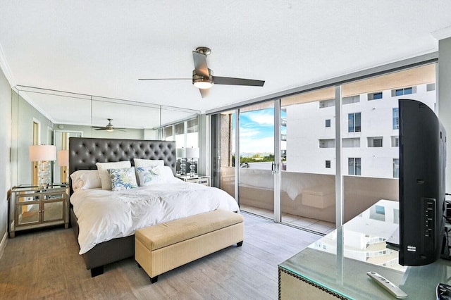 bedroom featuring access to exterior, a ceiling fan, ornamental molding, and wood finished floors