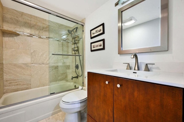 full bathroom with toilet, tile patterned floors, combined bath / shower with glass door, and vanity