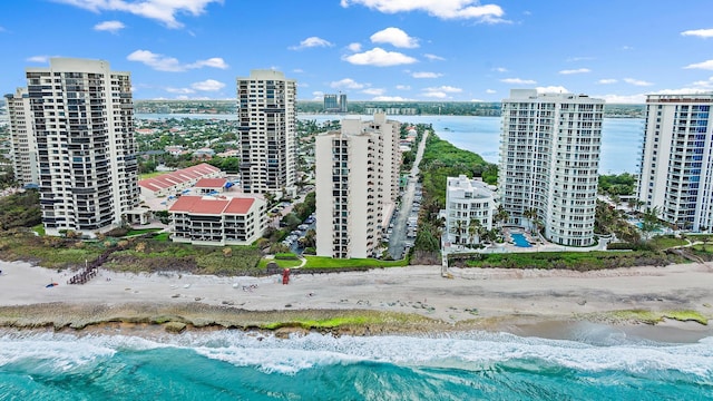 aerial view with a beach view, a water view, and a city view