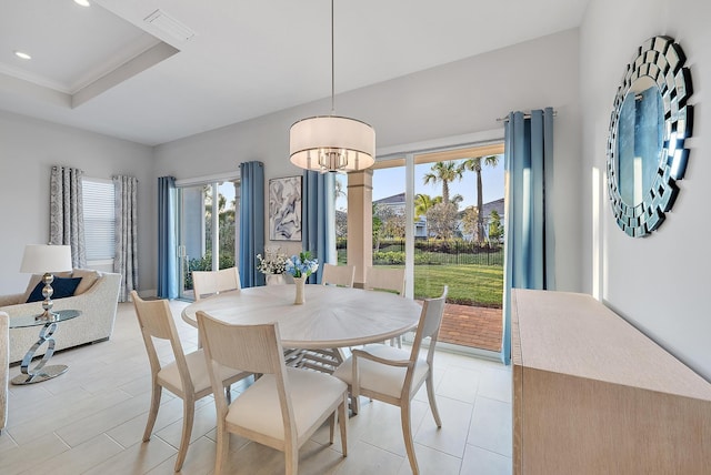 dining space with a raised ceiling, visible vents, and recessed lighting