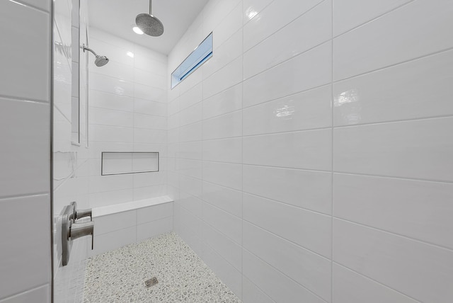 full bath featuring a tile shower