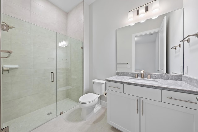 bathroom featuring toilet, a shower stall, vanity, tile patterned flooring, and baseboards