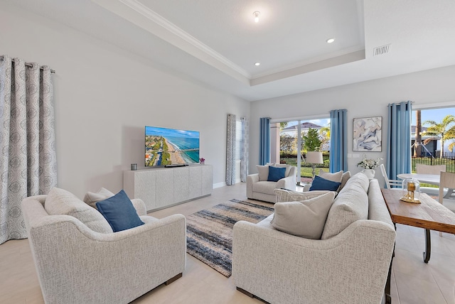 living room with light tile patterned floors, recessed lighting, visible vents, a raised ceiling, and crown molding