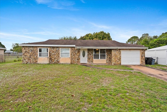 ranch-style house with a garage, fence, concrete driveway, stone siding, and a front lawn