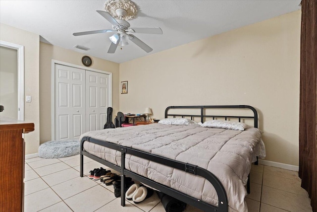 314 SW Cherry Hill Rd, Port Saint Lucie, FL 34953 - bedroom featuring baseboards, visible vents, a ceiling fan, tile patterned floors, and a closet