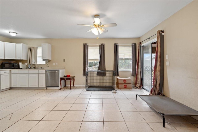 314 SW Cherry Hill Rd, Port Saint Lucie, FL 34953 - kitchen featuring light countertops, light tile patterned flooring, a sink, white cabinetry, and dishwasher