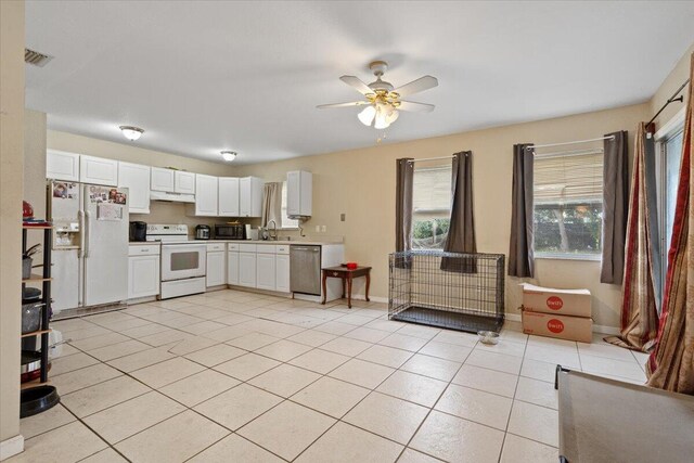 314 SW Cherry Hill Rd, Port Saint Lucie, FL 34953 - kitchen featuring light tile patterned floors, a ceiling fan, white cabinetry, white appliances, and baseboards