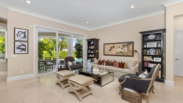 sitting room with baseboards, crown molding, and recessed lighting