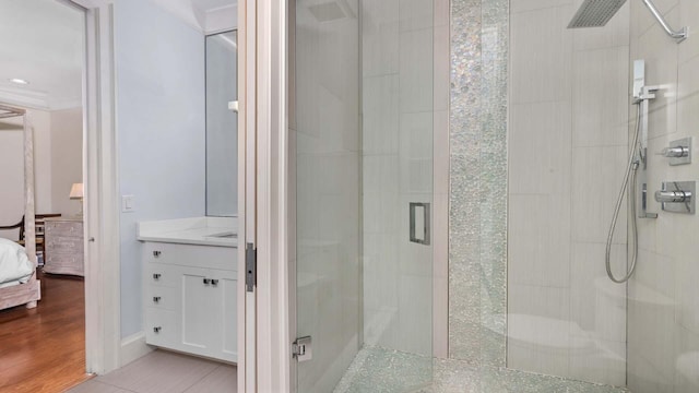 bathroom with tile patterned flooring, a shower stall, connected bathroom, and vanity