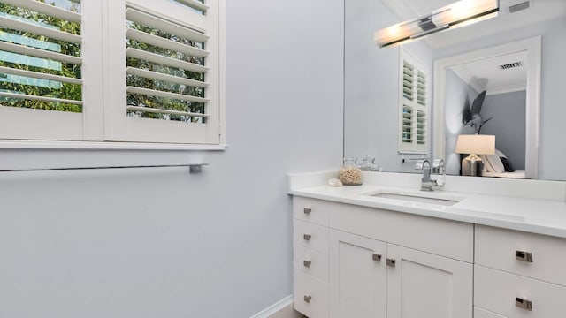 bathroom with visible vents, vanity, and baseboards