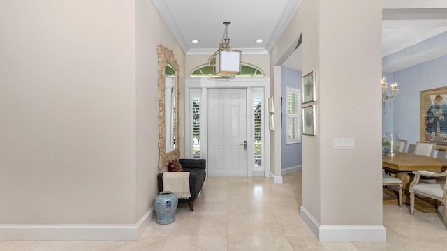 entrance foyer with recessed lighting, baseboards, a chandelier, and ornamental molding