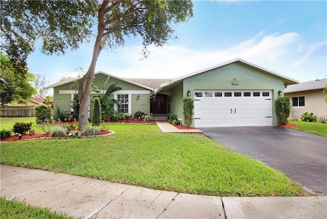 single story home featuring a garage, fence, driveway, stucco siding, and a front yard