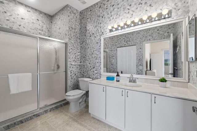 full bath with toilet, a stall shower, tile patterned flooring, and vanity