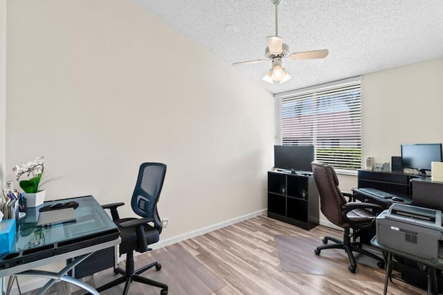 office area with ceiling fan, baseboards, a textured ceiling, and wood finished floors