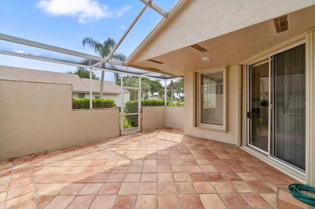 view of patio / terrace featuring glass enclosure