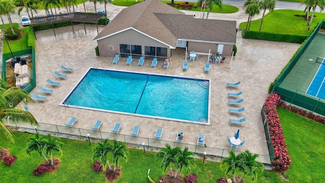 pool with a yard, fence, and a patio