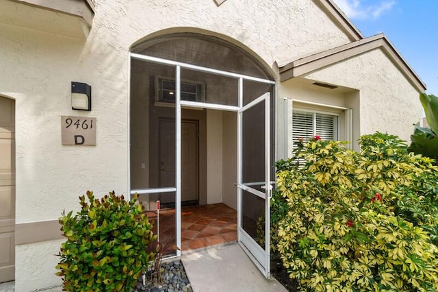 doorway to property with stucco siding