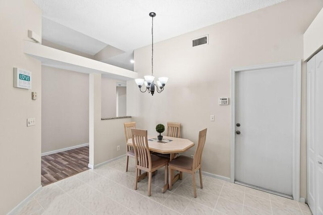 tiled dining space with baseboards, visible vents, and a chandelier