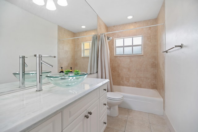 bathroom with toilet, tile patterned floors, vanity, baseboards, and shower / tub combo with curtain