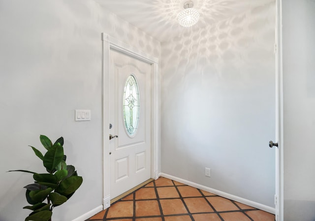 foyer with light tile patterned floors and baseboards