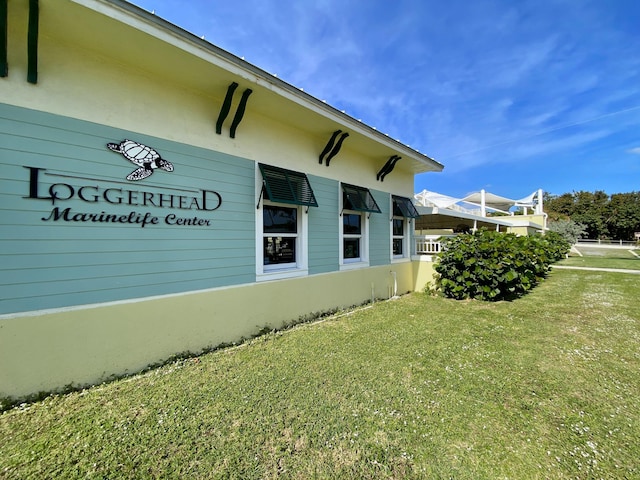 view of side of property with a lawn