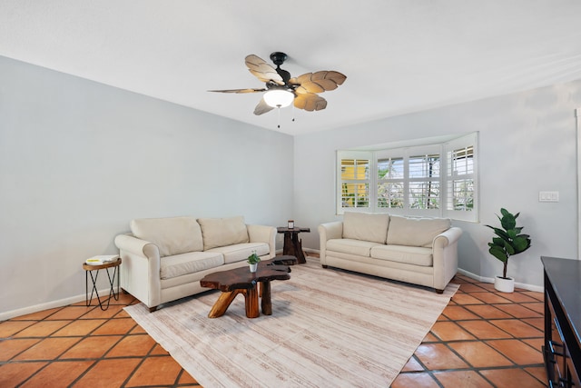 living room with ceiling fan, light tile patterned floors, and baseboards