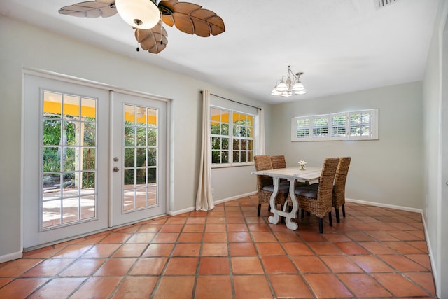 dining room featuring french doors, light tile patterned flooring, baseboards, and ceiling fan with notable chandelier