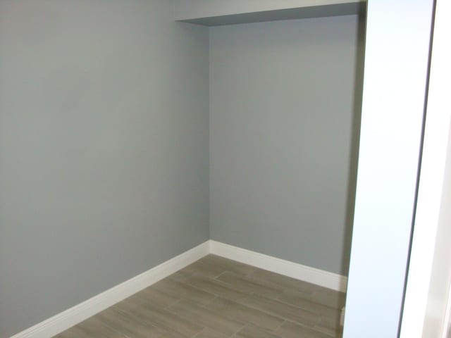 interior space featuring light wood-type flooring and baseboards