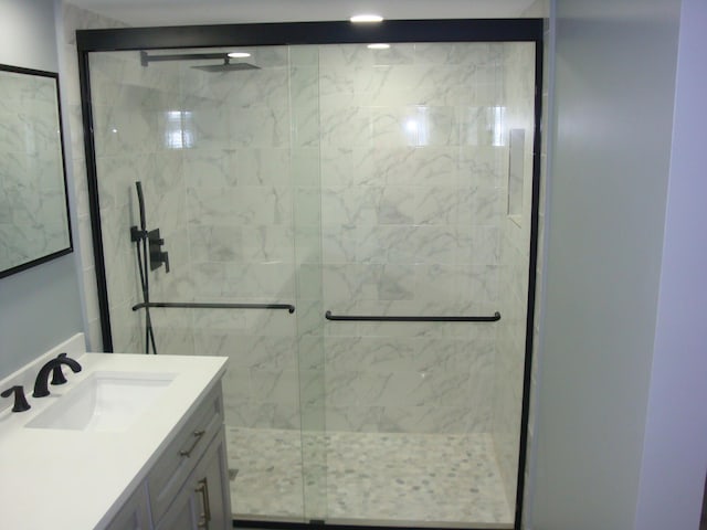 full bathroom featuring a stall shower and vanity