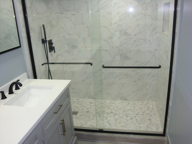 bathroom featuring vanity and a shower stall