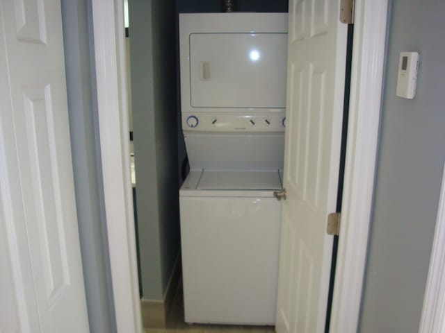 laundry area featuring laundry area and stacked washer / drying machine