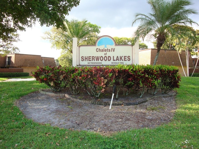 community / neighborhood sign with a lawn