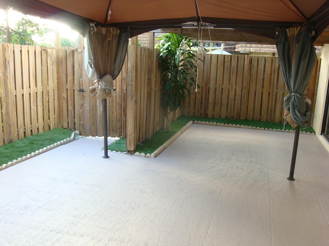 view of patio / terrace featuring fence and a gazebo