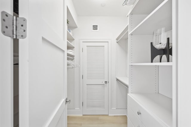 walk in closet with visible vents and light wood finished floors