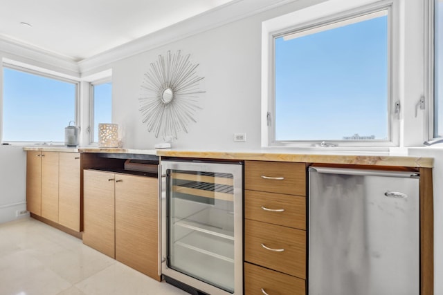 kitchen with light countertops, wine cooler, light tile patterned floors, and crown molding