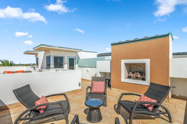 view of patio featuring an outdoor fireplace