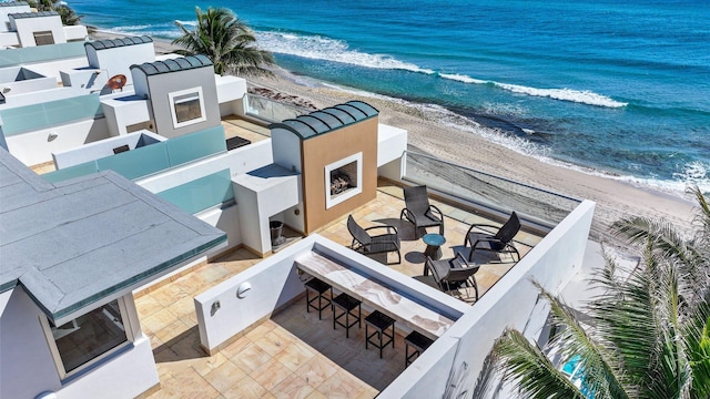 bird's eye view featuring a water view and a view of the beach