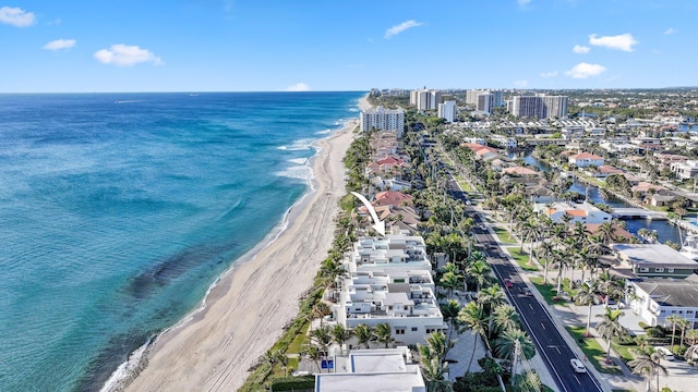 birds eye view of property featuring a beach view and a water view