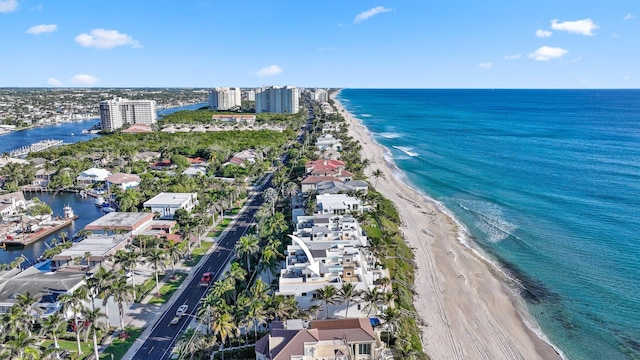 birds eye view of property with a beach view and a water view