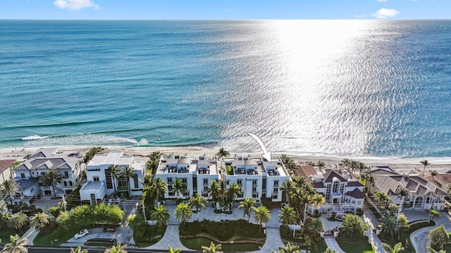 aerial view featuring a view of the beach, a residential view, and a water view