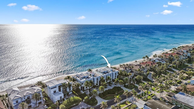 aerial view with a residential view, a beach view, and a water view