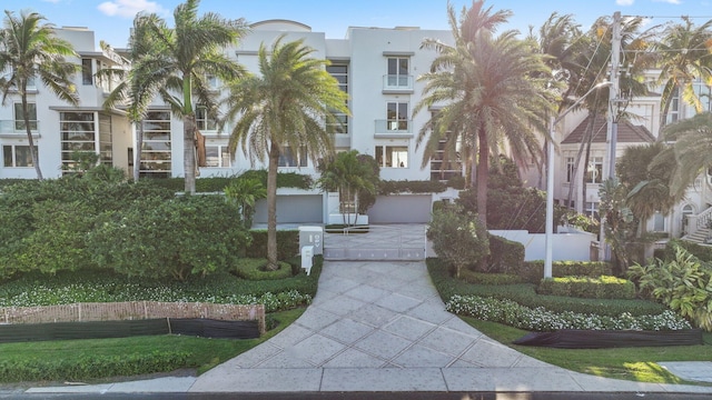 view of property's community with concrete driveway and a garage