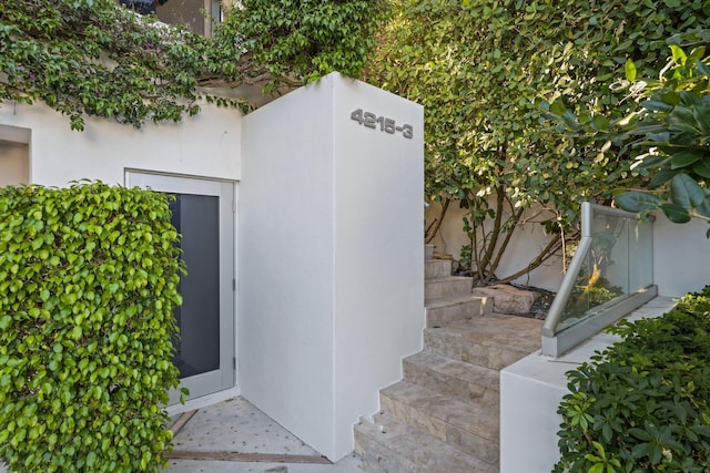 property entrance with stucco siding