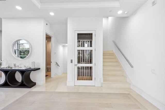 staircase featuring recessed lighting, a tray ceiling, visible vents, and ornamental molding