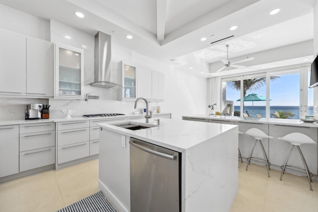 kitchen featuring modern cabinets, white cabinetry, dishwasher, and wall chimney range hood