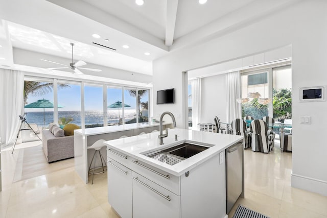 kitchen with a sink, dishwasher, an island with sink, and a healthy amount of sunlight