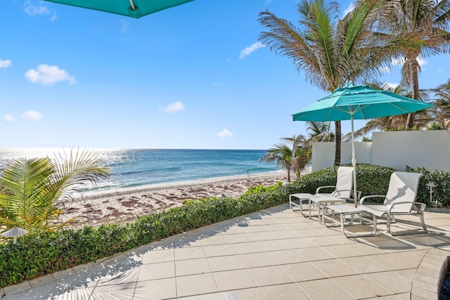 property view of water with a beach view and fence