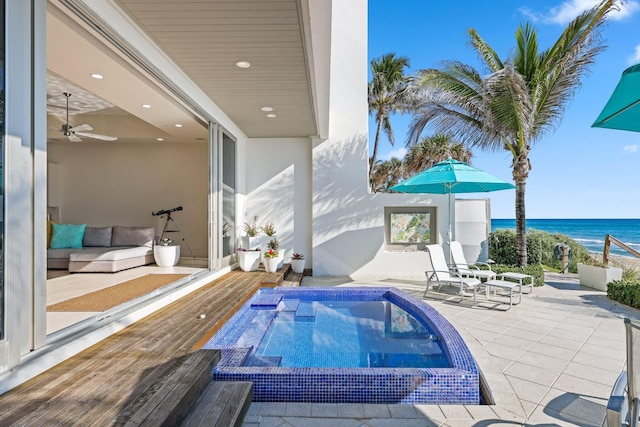 view of pool featuring a water view, outdoor lounge area, and a patio area