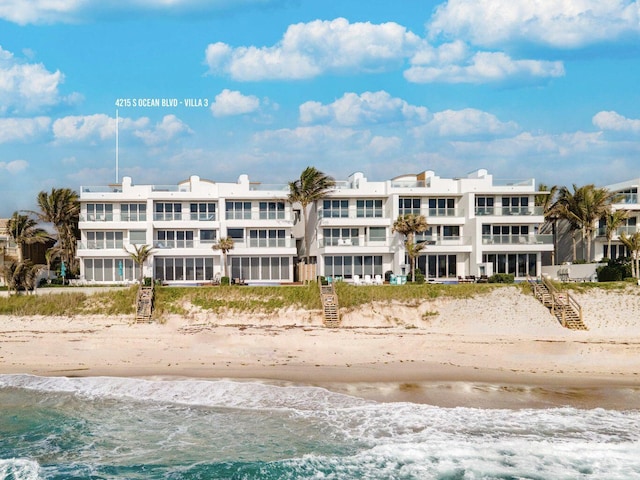 view of property featuring a view of the beach and a water view