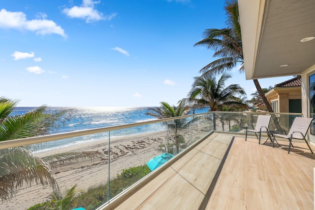 balcony with a view of the beach and a water view